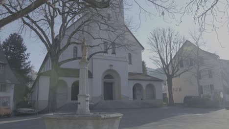 Front-view-of-the-church-of-Saint-Urban-in-Freiburg,-Germany,-empty-square-in-the-early-morning