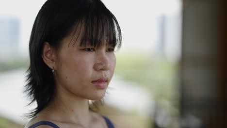 close-up portrait of a young asian woman with a pensive expression