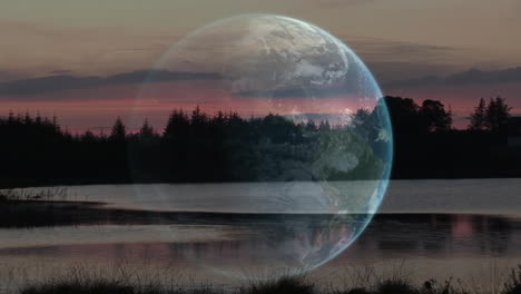 earth animation over serene lake landscape with trees and sunset sky