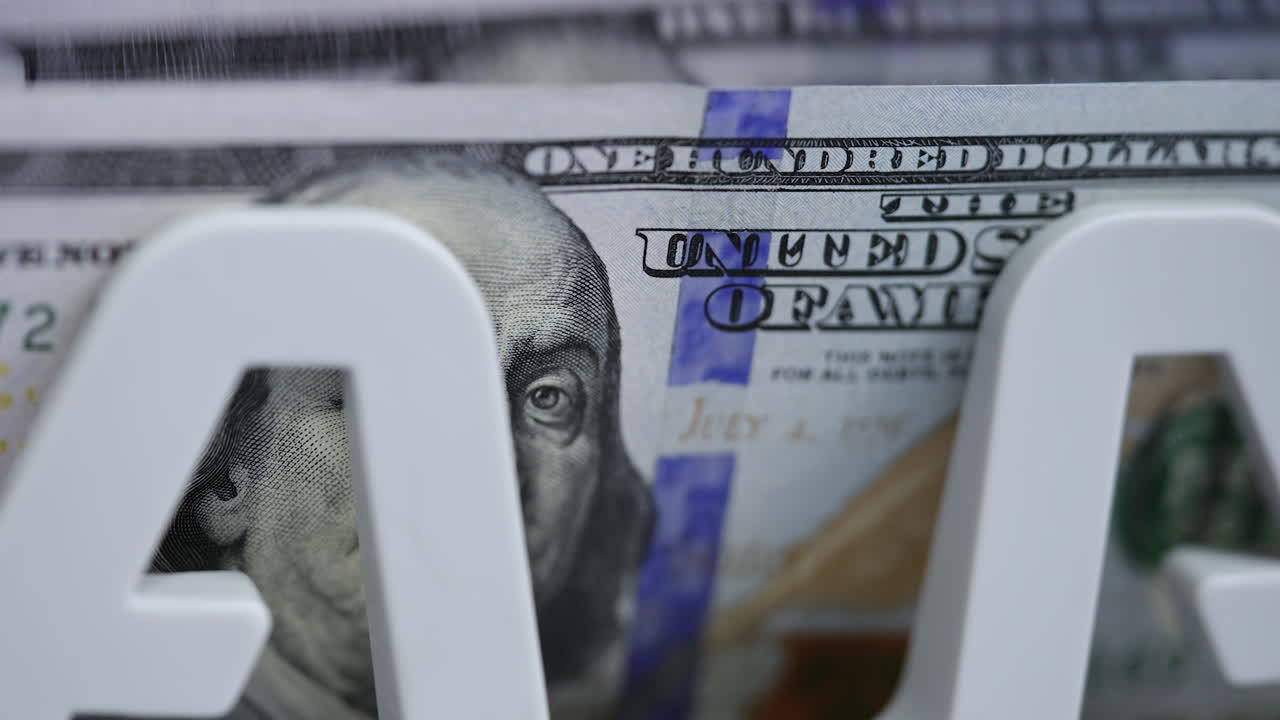 Cash money counting machine. Banknote counter are counting one hundred dollar bills. Macro shot.