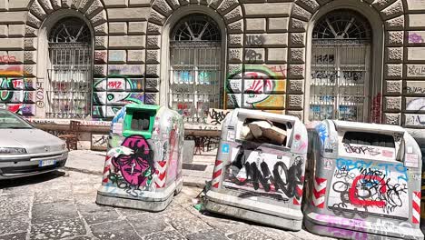 colorful bins with graffiti in naples, italy