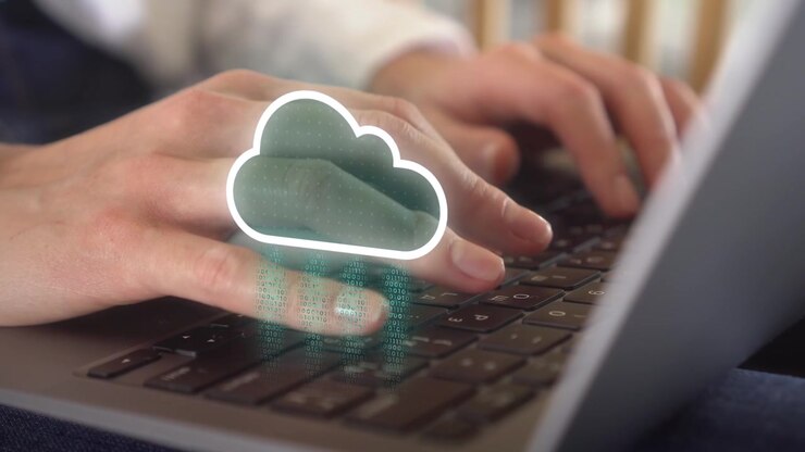Closeup of woman using her laptop with data being synchronized to cloud computing online storage and IOT network connectivity for devices. Blockchain, Cloud storage, Data center analytics, AI concept