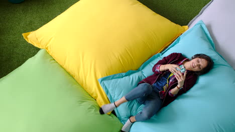 relax, pillow and student on smartphone for social