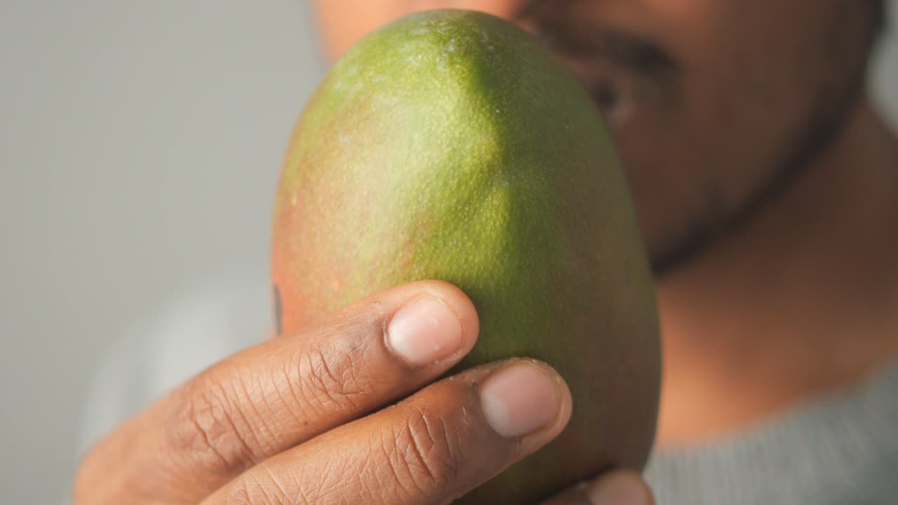 Person Holding a Mango