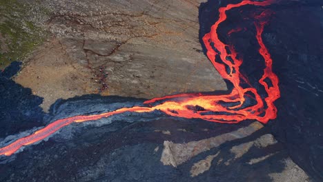 river of lava flowing down during volcano eruption, fagradalsfjall, southwest iceland - aerial drone shot