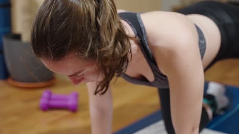 Close-up-shot-of-female-teenager-doing-fitness-workout-at-home-during-covid19-pandemic