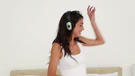 brunette haired woman dancing while listening to music