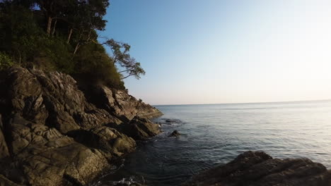 Toma-Cinematográfica-Fpv-De-Olas-Rompiendo-Contra-El-Acantilado-En-Phuket,-Tailandia