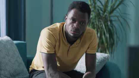 portrait of a serious man sitting indoors