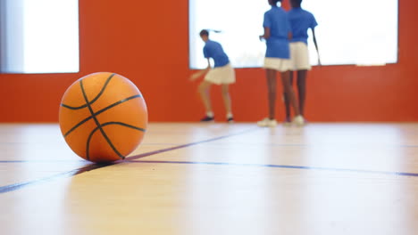 playing basketball in school gym, kids in sports uniforms having fun, copy space