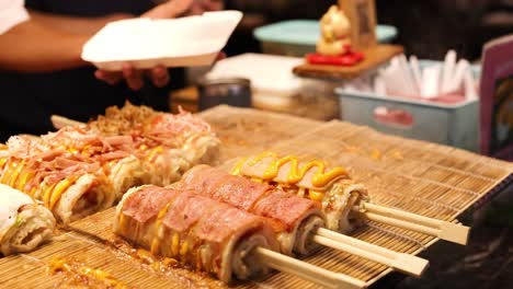 chef prepares and serves japanese rice rolls