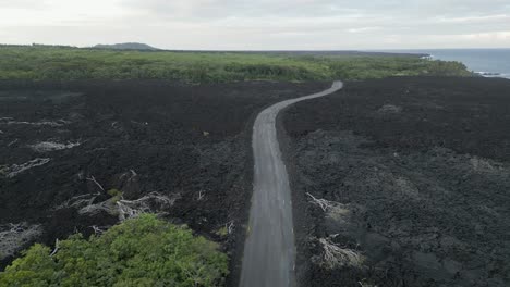 Aerial:-New-road-crosses-recent-black-lava-flow-on-coast-of-Hawaii