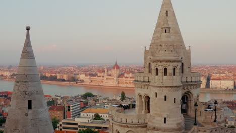 The-view-from-Fisherman’s-Bastion-during-sunset,-overlooking-the-Danube-River,-with-the-Hungarian-Parliament-Building-on-the-riverside