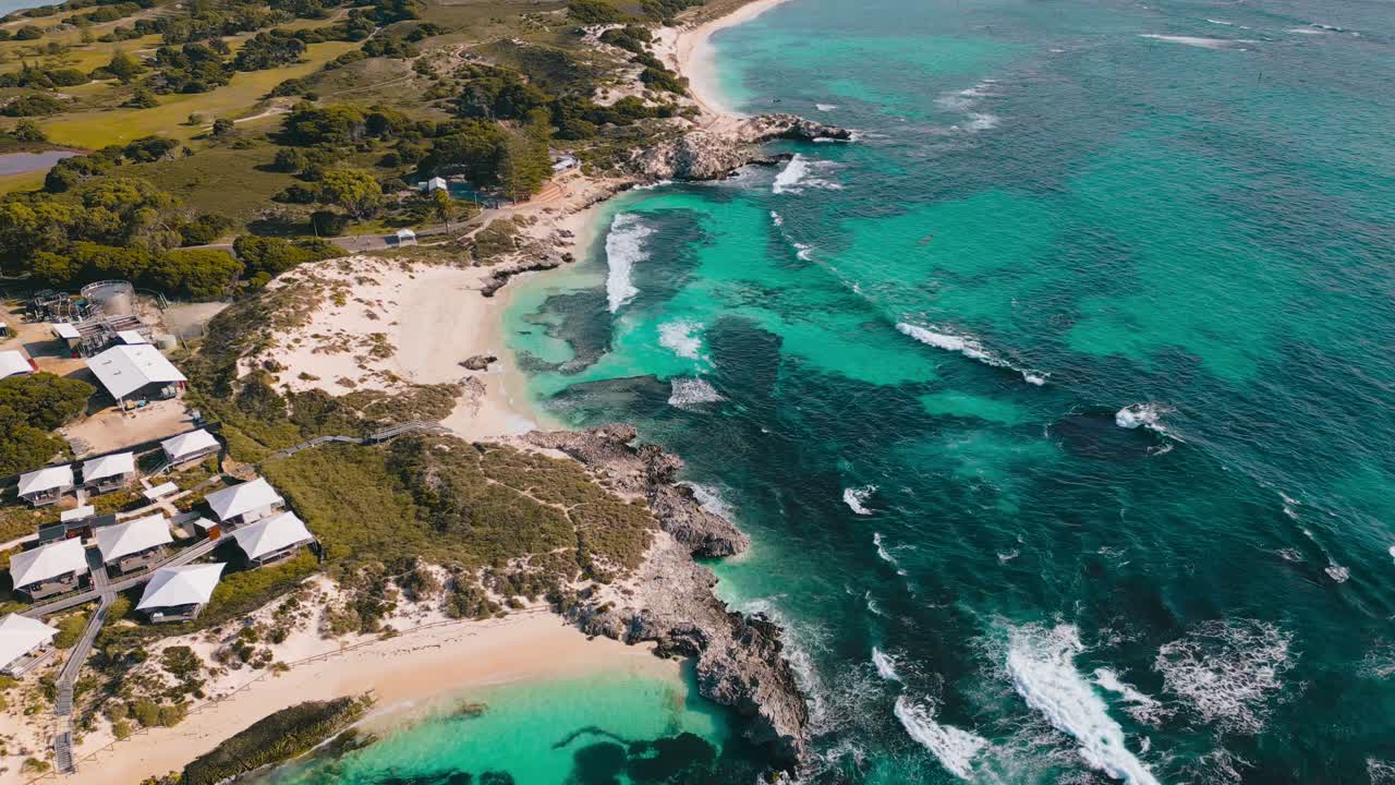 Stunning cinematic drone footage of turquoise waters surrounding the famous Rottnest Island and its beaches, where tourists flock to visit the cute Quokkas