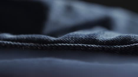 closeup shot of seam in blue denim fabric during manufacturing process of designer clothing