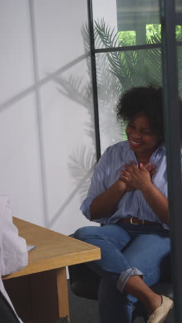 vertical video of relieved woman being given all clear shaking hands with doctor or oncologist at meeting in treatment clinic for breast cancer in hospital