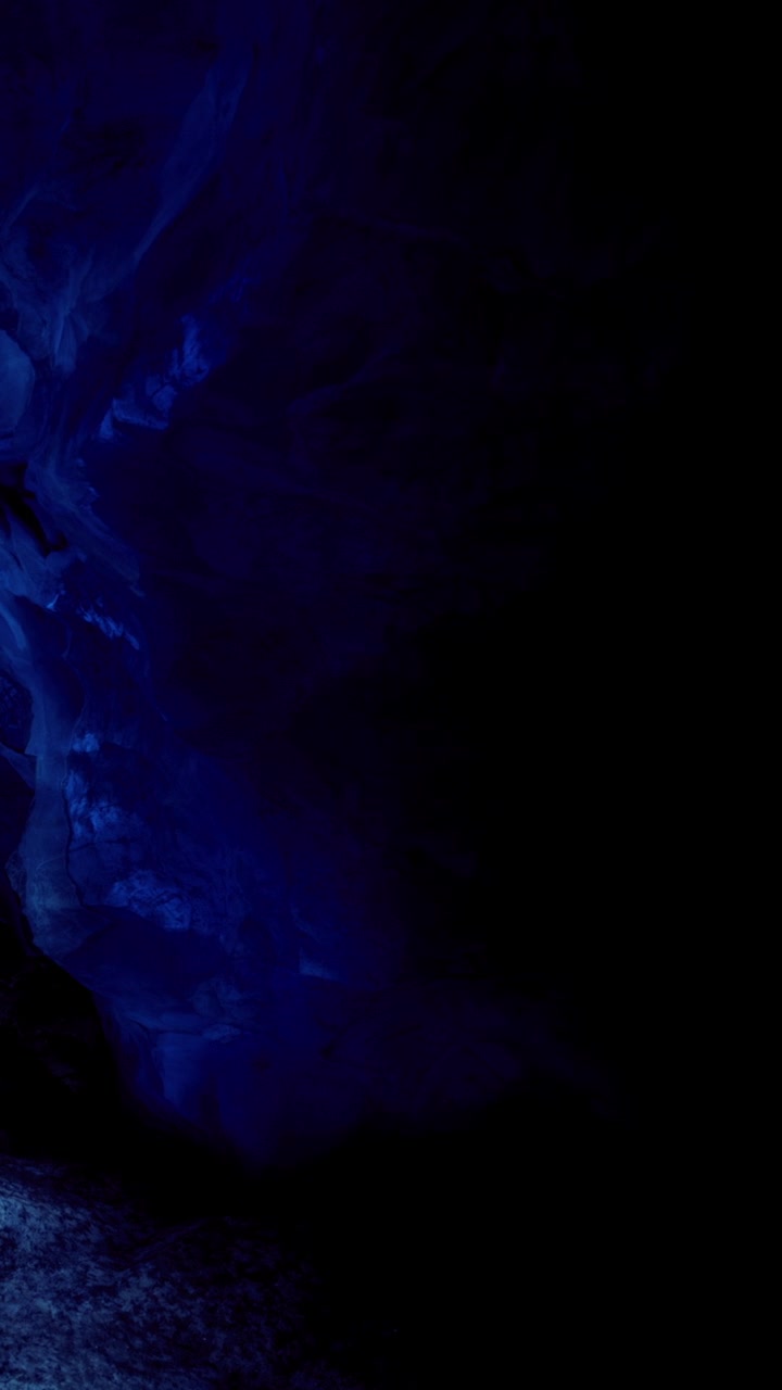 Ethereal blue glow bathes the hidden cave in enchanting light and mystery