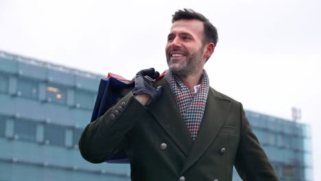 Mature-man-with-shopping-bags-walking-the-street