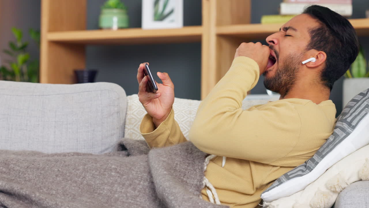 Sick man yawning while watching