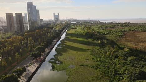 aerial of vast green landscape next to skyscrapers in buenos aires