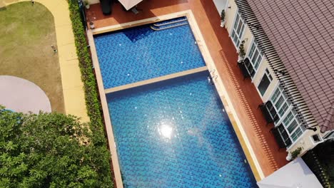 Aerial-Footage-of-Tuscan-Style-Outdoor-Swimming-Pool-on-Sunny-Day