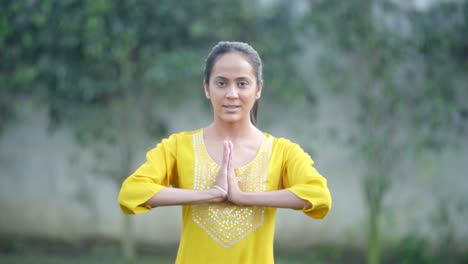 indian girl doing namaskar yoga pose