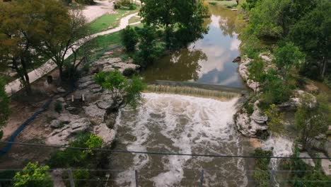 Round-Rock-Memorial-Park-Chisholm-Trail-Train-bridge-and-waterway-aerial-drone-push-in-on-sunny-day-in-4k