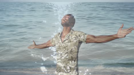 Animation-of-sea-over-african-american-man-with-arms-outstretched