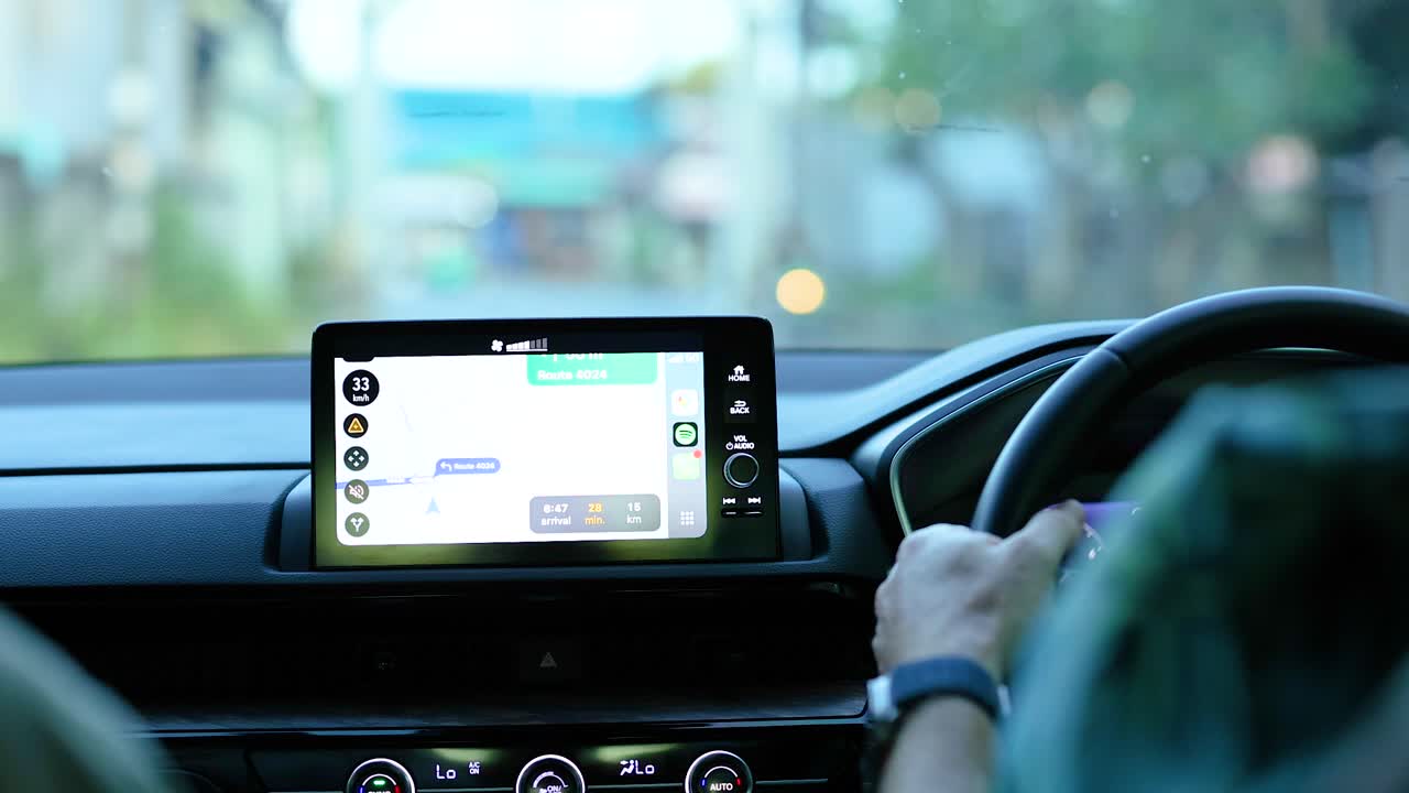 A driver uses a Carplay touchscreen while navigating through Phuket. The video captures a calm, focused driving experience