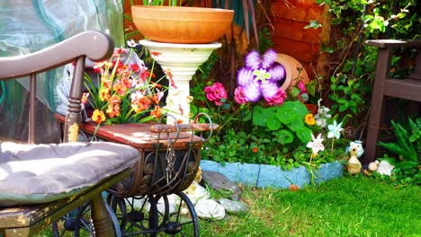 colourful spinning childlike windmills blowing in breeze among variety of blossoming plants and flowers