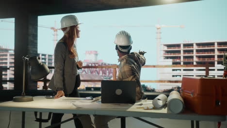 engineers and architects discussing plans at a construction site