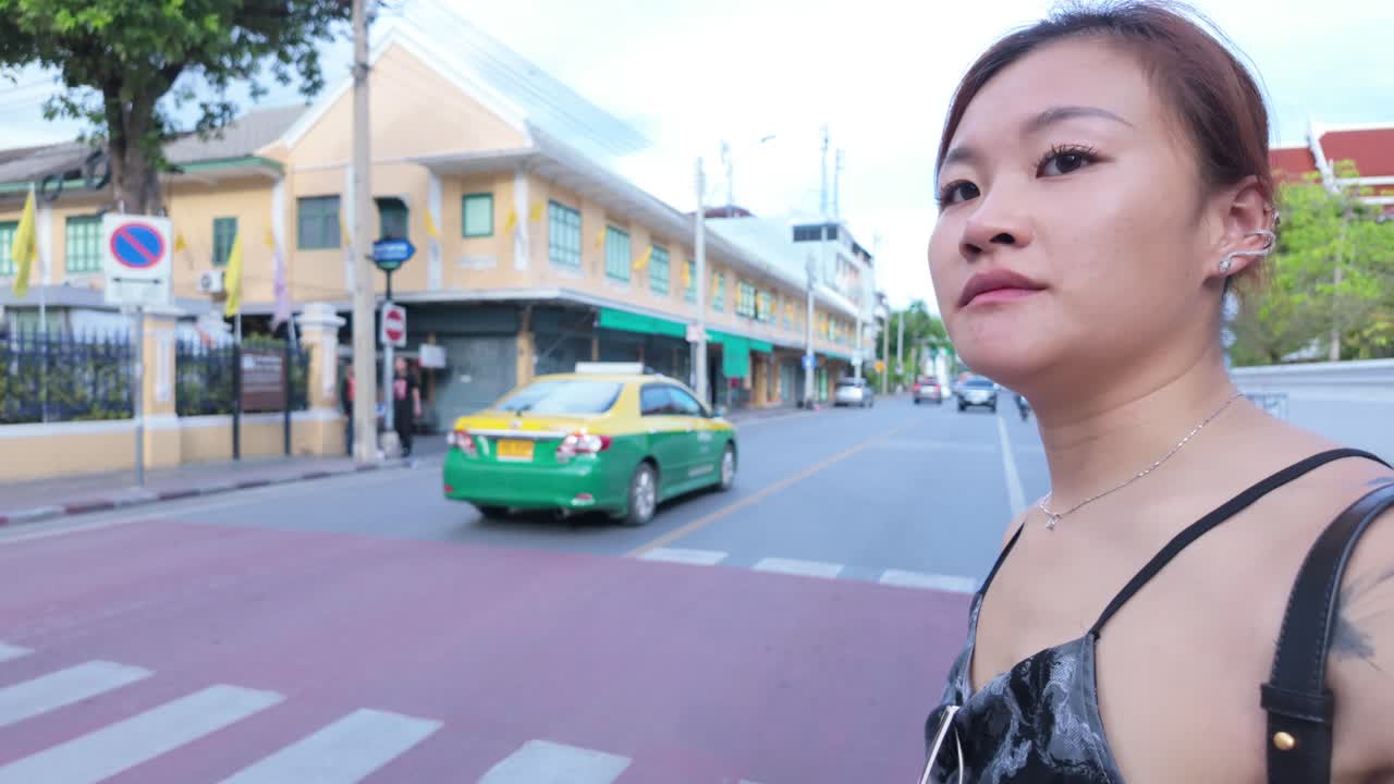 Woman Walking in a Thai City Street