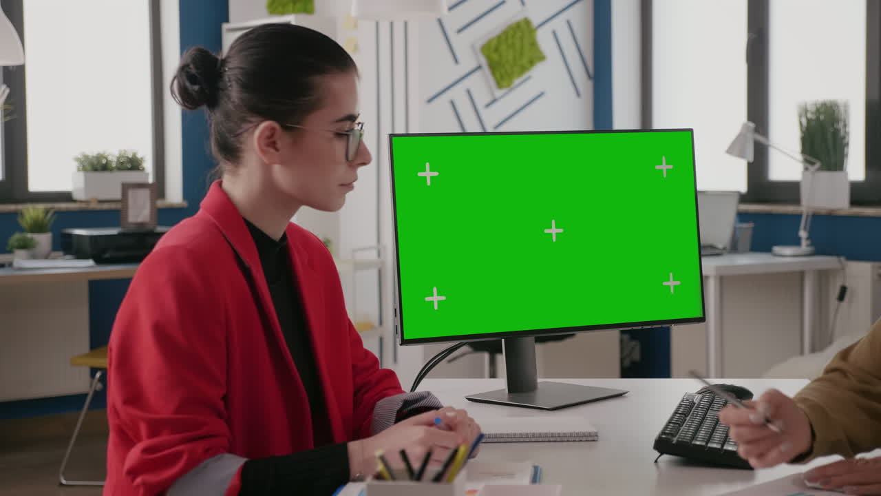 Close up of woman looking at computer with green screen