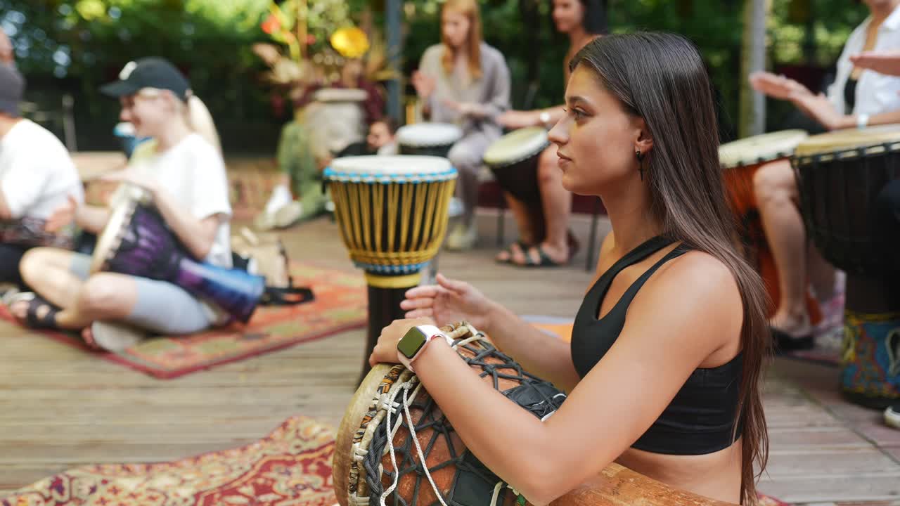 People Playing Djembes in a Drum Circle