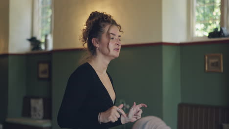 a woman with curly hair standing in a room