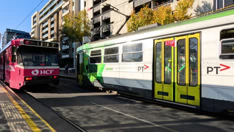 two trams with advertisements in melbourne