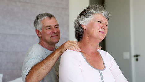 Woman-enjoying-shoulder-massage-given-by-her-husband