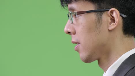 profile view of young asian businessman smiling