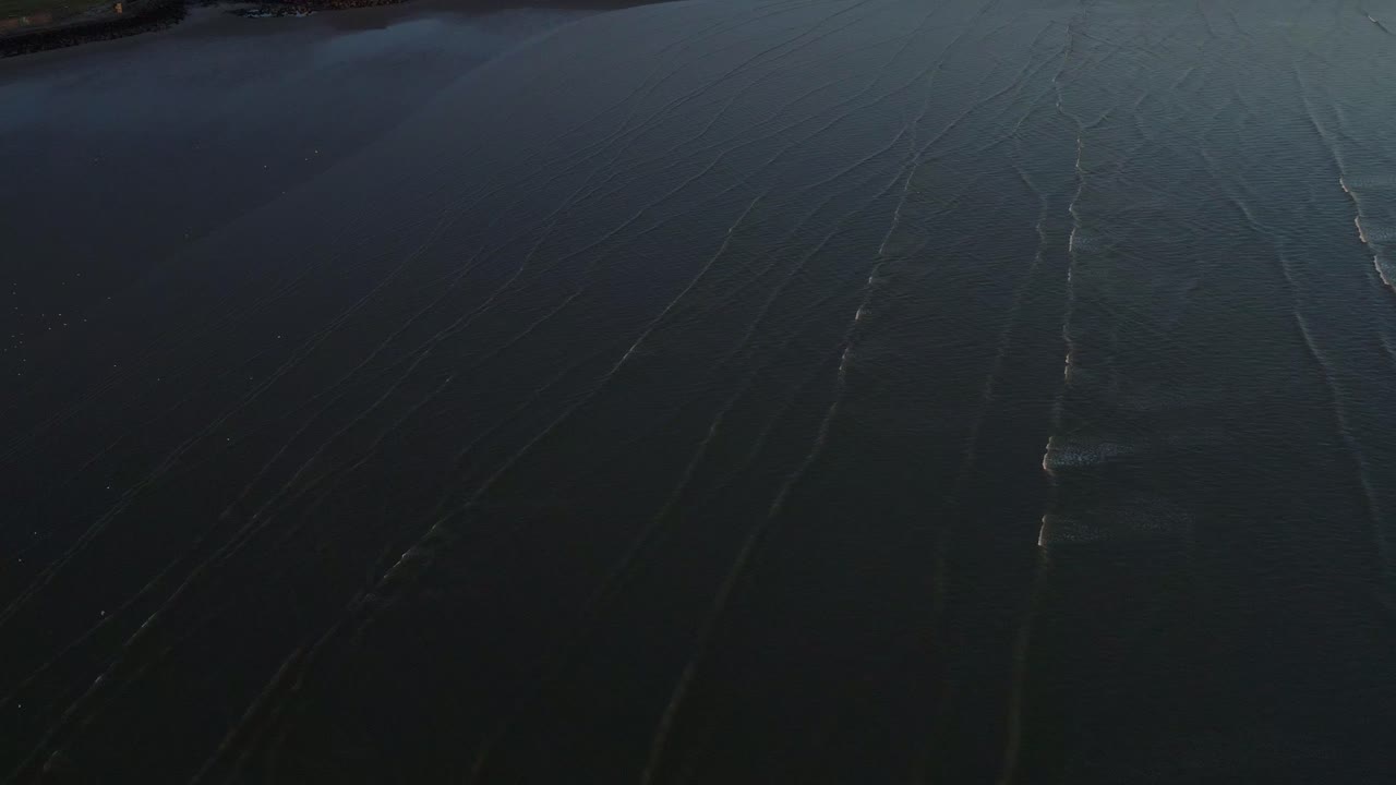 Birds eye view of ocean waves at Ireland at low tide in the evening