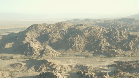 smokey flight over mount whitney portal road in california's alabama hills