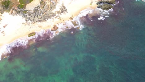 aerial-view-of-rugged-coast-line-with-blue-ocean-and-waves-crashing,-portugal,-4k