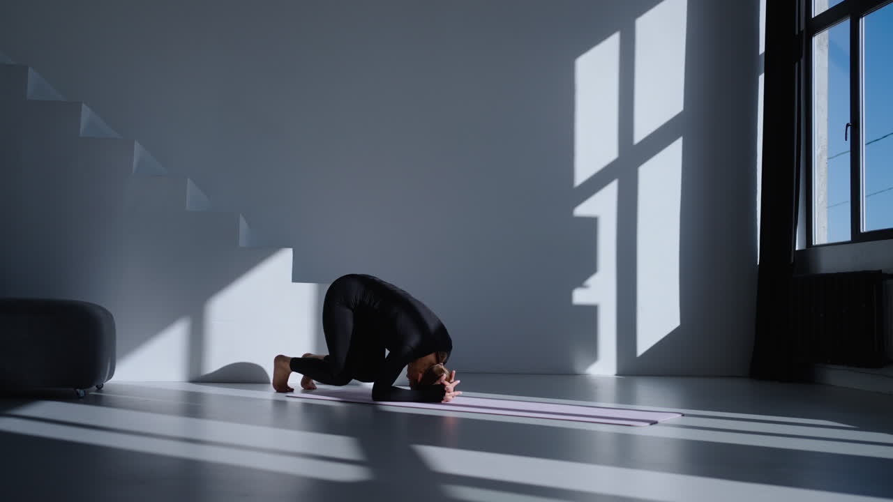 Woman doing yoga inversion pose in studio