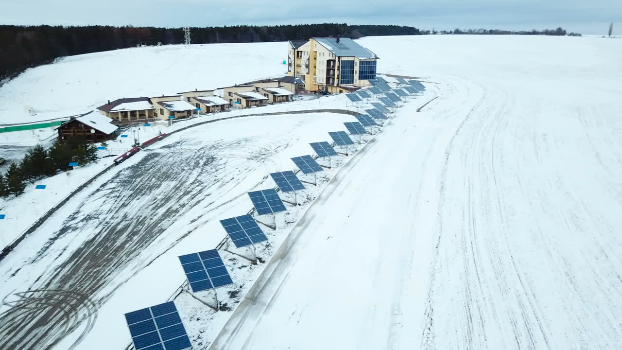 Recreation center with solar panels covered with snow on the outskirts of the city.