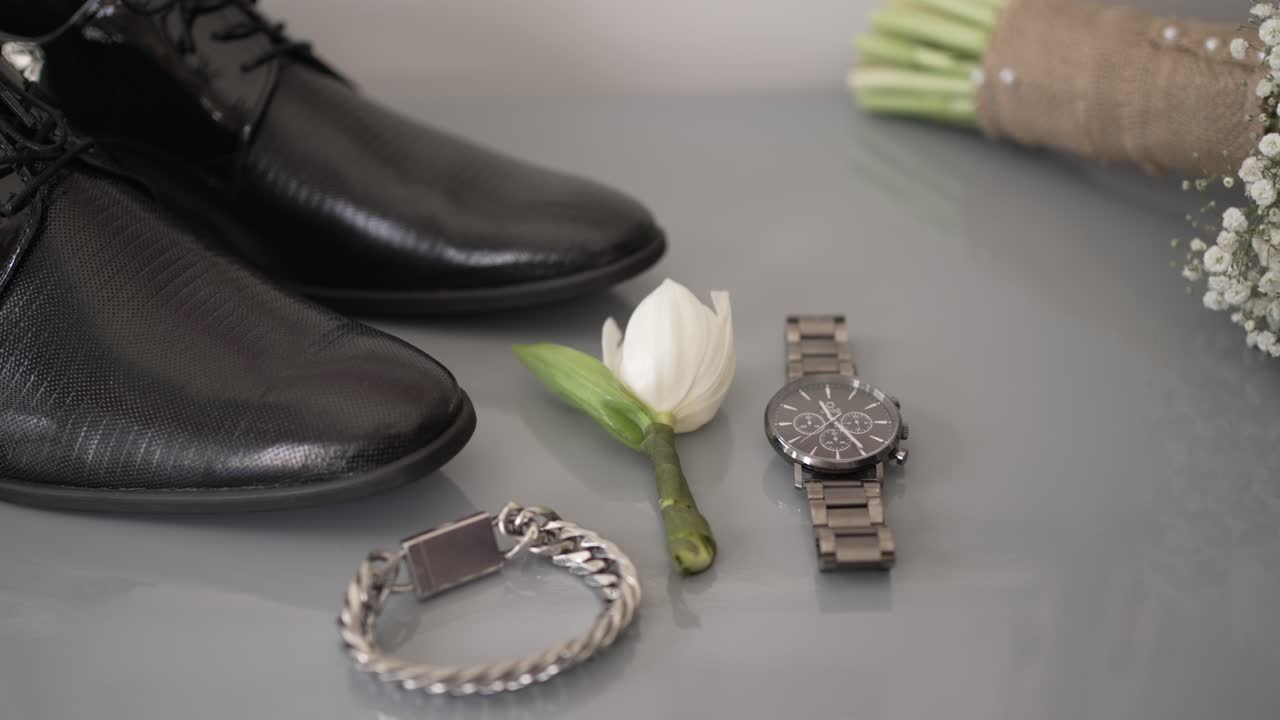 elegant groom accessories arranged for wedding day preparation