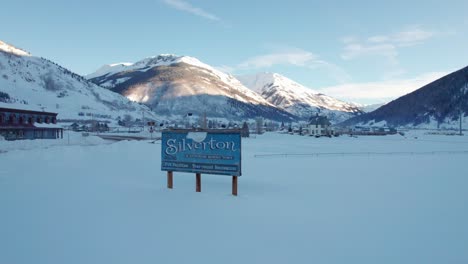 Drone-aerial-view-of-Silverton,-Colorado-welcome-sign-in-the-winter