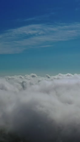 clouds atmosphere. flying over white clouds in the sky. beautiful background of soft clouds moving slowly. aerial view. vertical video