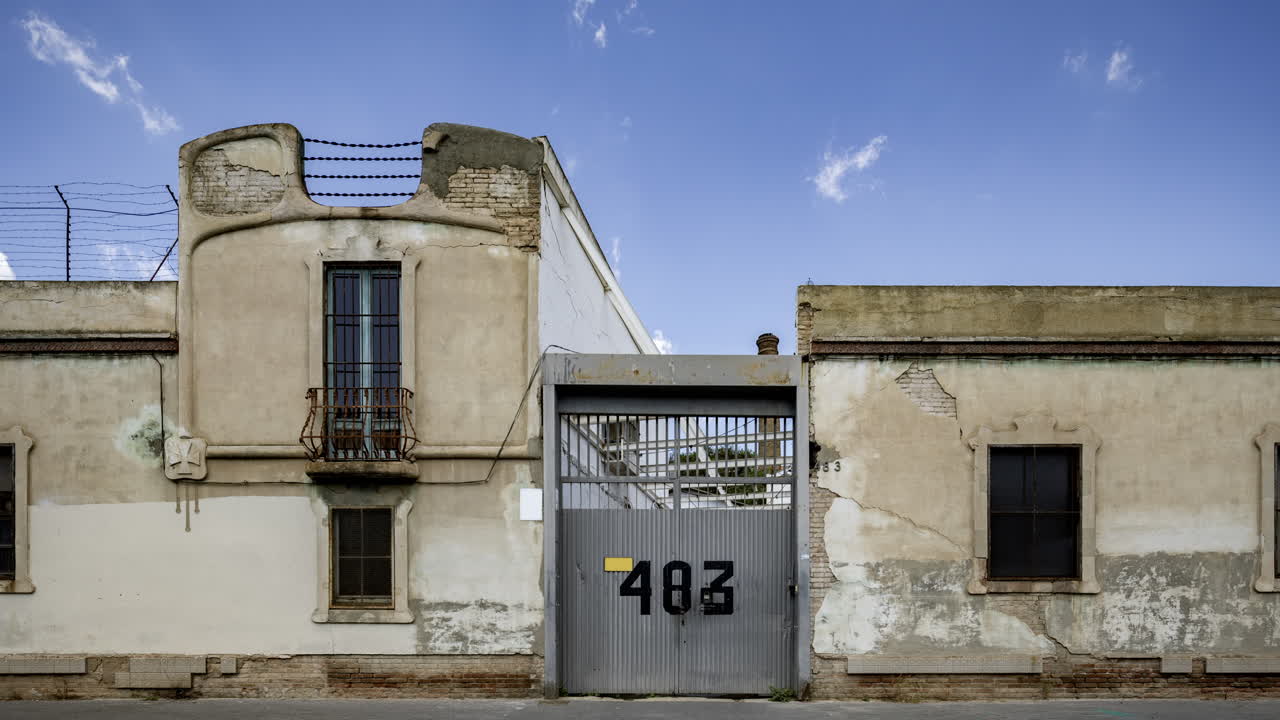 Old factory and industrial complex with passing clouds