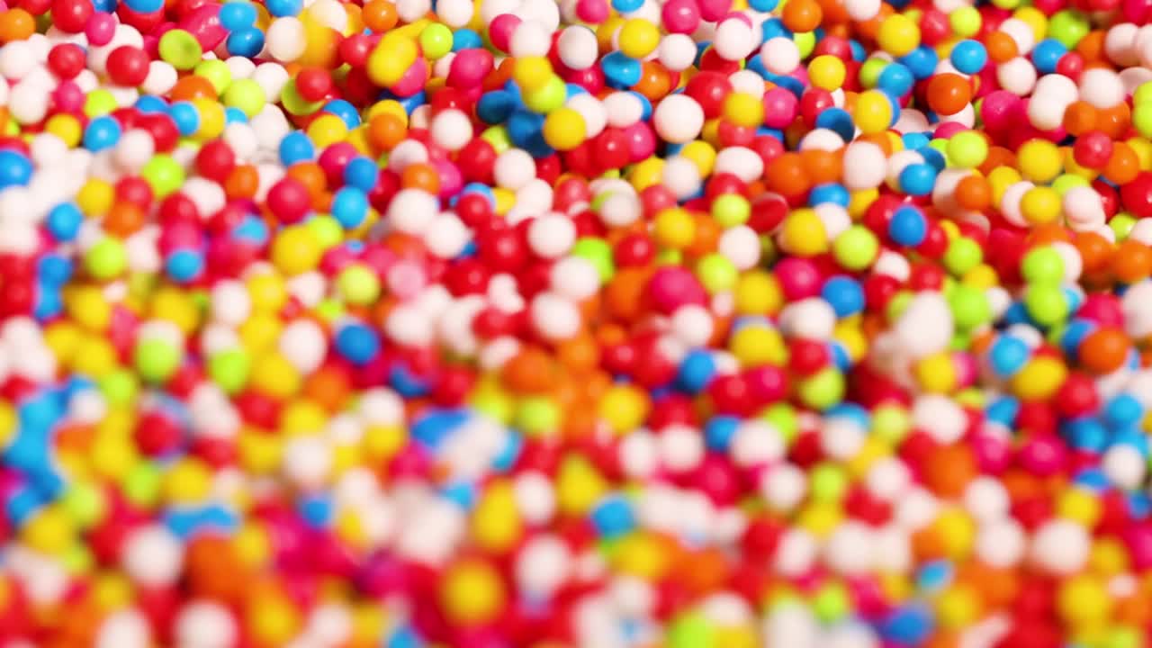 A detailed close-up of vibrant, multicolored sprinkles creating a lively and colorful pattern.