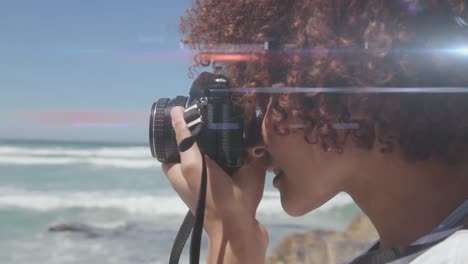 Spot-of-light-against-african-american-female-photographer-clicking-pictures-with-digital-camera