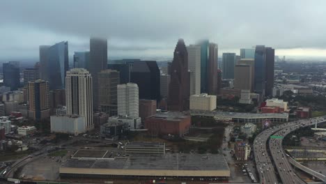 this video is about an aerial of downtown houston on a rainy and cloudy day